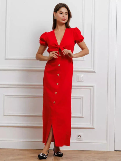 Maxi Dress Riviera Flame: Bold red maxi dress with tie-front bodice, puff sleeves, and button-down skirt for elegant style.