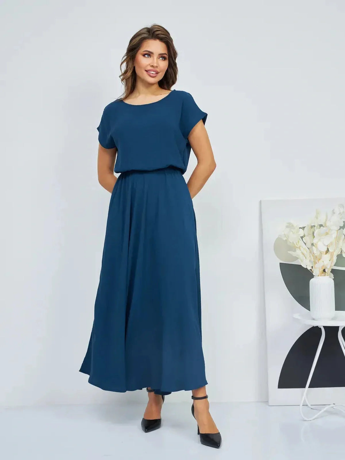 Model wearing Verona Maxi Dress, a lightweight, elegant summer dress with pockets and a flattering cinched waist.