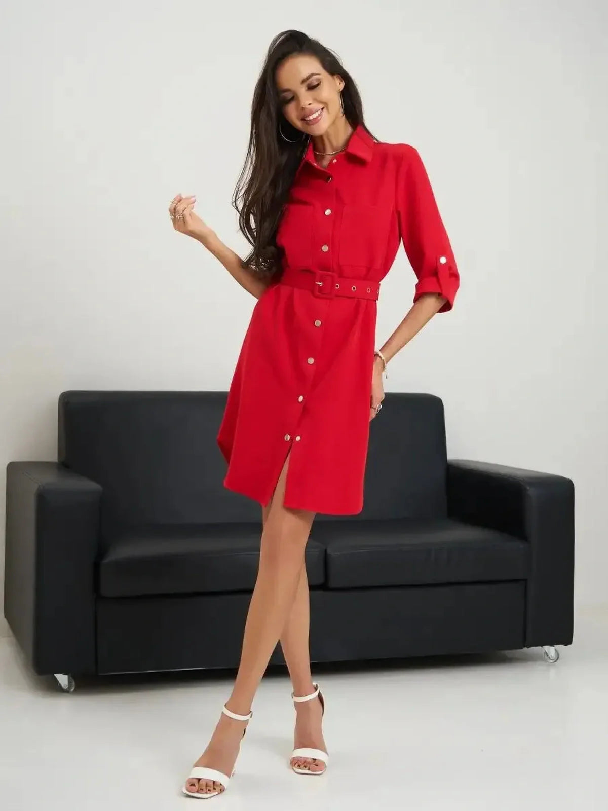 Model showcasing the Scarlet Belted Mini dress in red, featuring a buttoned shirt-dress design and a waist-cinching belt.