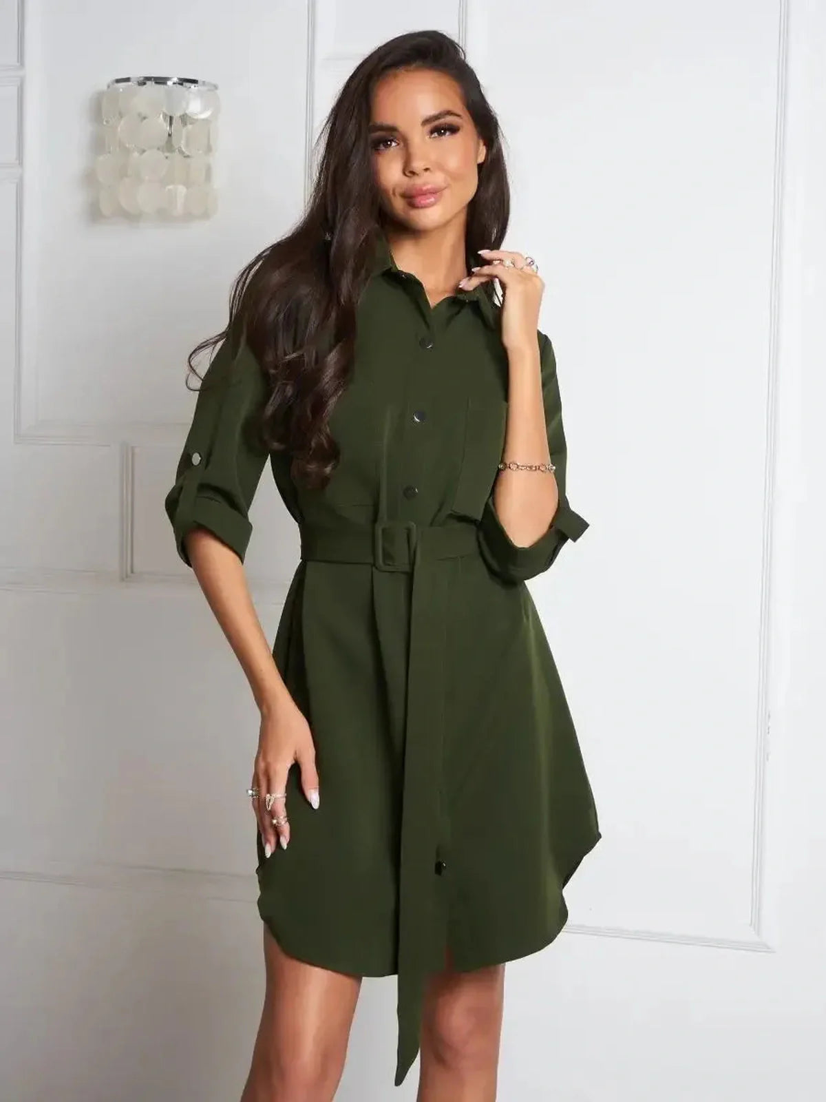 Olive green belted shirt mini dress featuring a polished snap-button front and a flattering silhouette.