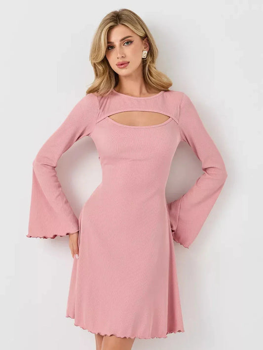 Model wearing a pink Blush Whisper dress with flared sleeves and U-neckline, showcasing feminine elegance and style.
