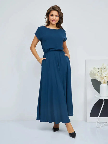 Verona Maxi Dress in dark blue featuring a flowy silhouette and pockets, perfect for summer elegance.