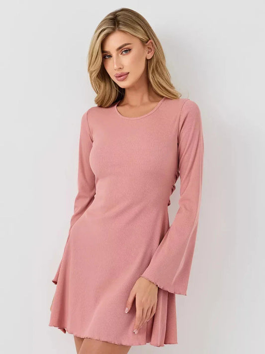Woman wearing a stylish pink mini dress with long flared sleeves and U-neckline, embodying summer elegance.