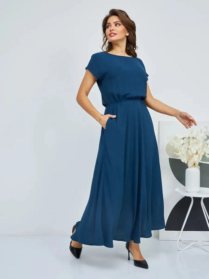 Elegant woman in a flowy navy Verona Maxi Dress with pockets, showcasing summer style and sophistication.