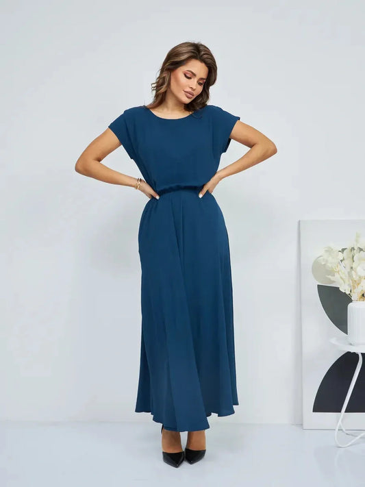 Verona Maxi Dress in deep blue, showcasing a flattering silhouette with pockets and a chic, effortless style for summer elegance.