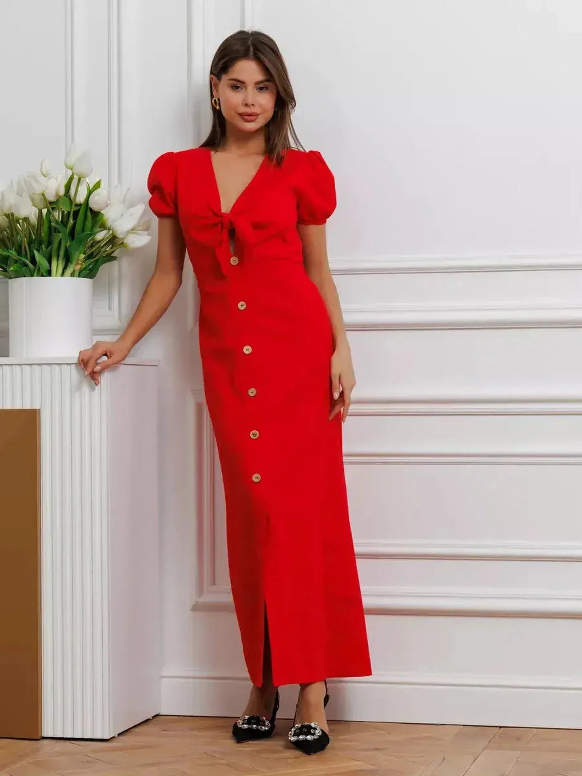 Maxi Dress Riviera Flame in red, featuring a tie-front bodice, puff sleeves, and a full-length button-down skirt.