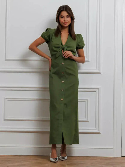Olive Whisper Maxi Dress featuring puff sleeves, tie front, and button details in an elegant khaki color.