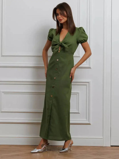 Olive Whisper Maxi Dress featuring puff sleeves, tie front, and buttons, embodying elegance in earthy tones.