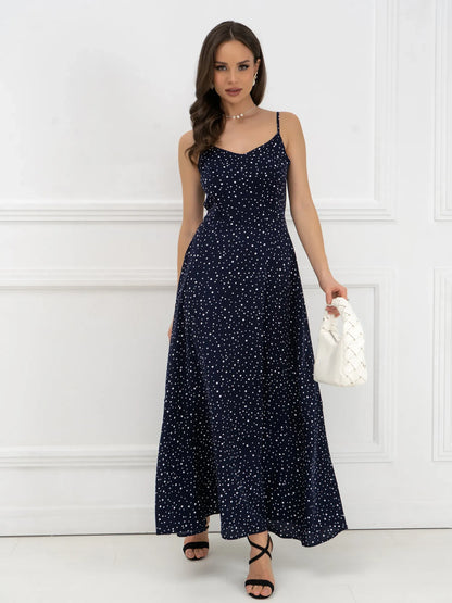 Model wearing a Noir Dots Maxi Dress in navy with white polka dots, showcasing its elegant A-line silhouette.