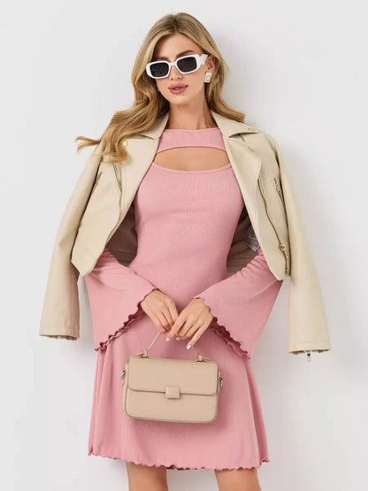 Stylish model showcasing the Blush Whisper pink dress paired with a chic jacket and handbag.