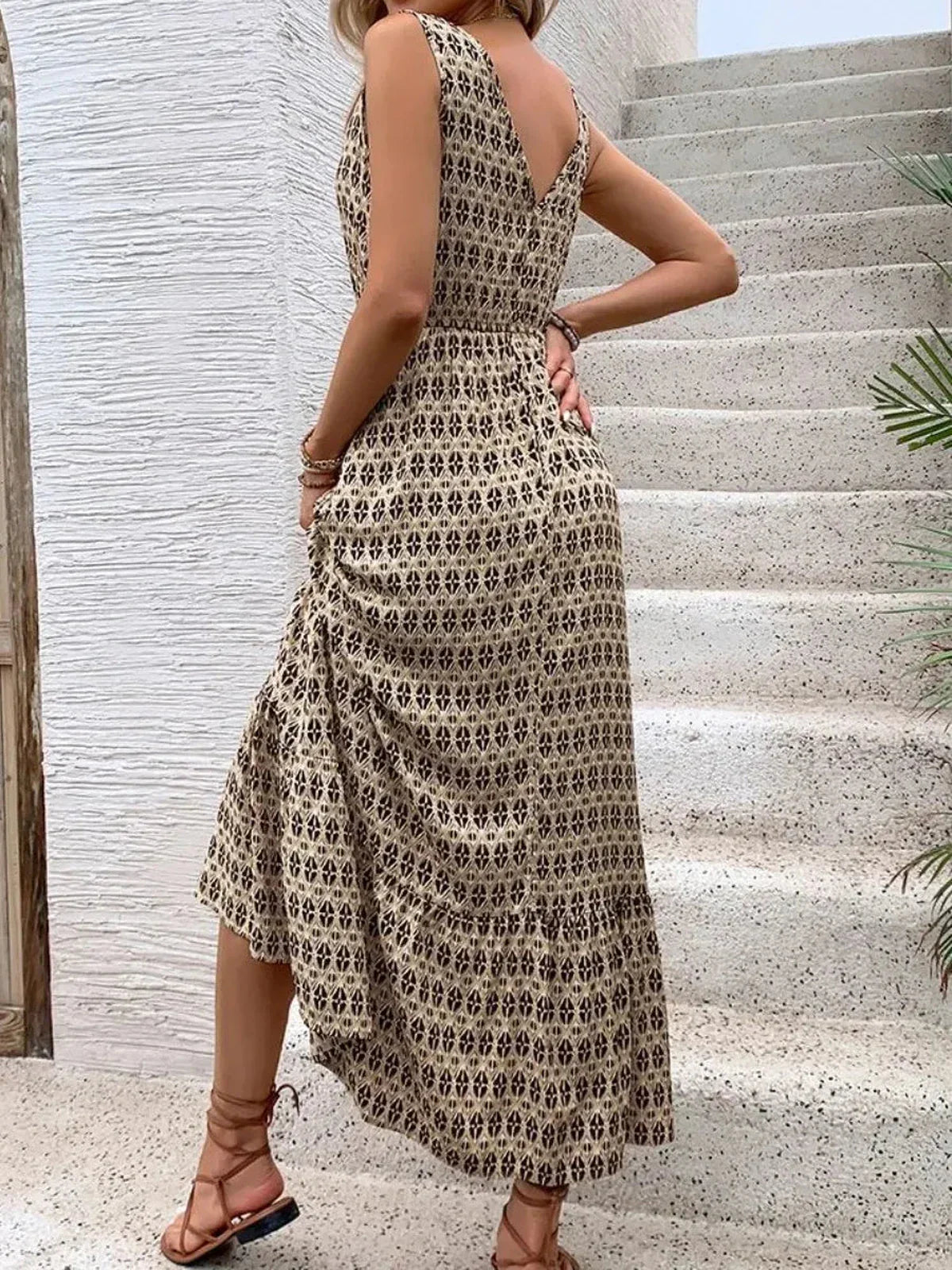 Elegant Solana Maxi Dress in boho print, showcasing a flowing silhouette and V-neckline against a textured backdrop.