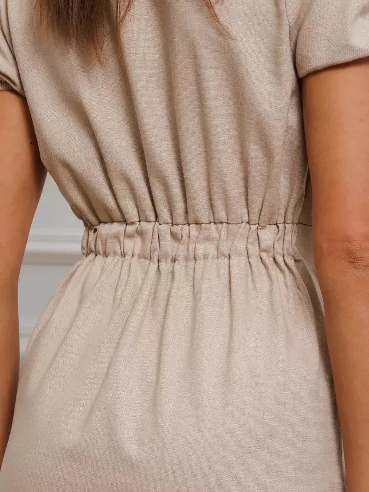 Close-up of the gathered waist of the Serene Bond Maxi Dress, showcasing its refined puff sleeves and elegant silhouette.