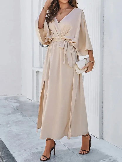 Serene Elegance Maxi Dress featuring a flowing silhouette, deep V-neckline, waist tie, and dramatic side slits.