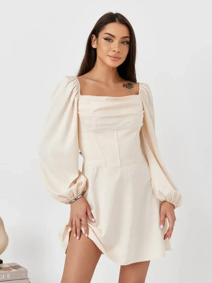 Lace Muse beige mini dress featuring a fitted corset bodice and puff sleeves, exuding effortless elegance.