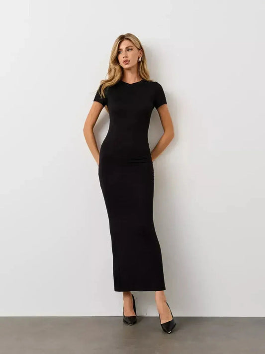 Model wearing Noir Curve Maxi Dress in black, showcasing its sculpted silhouette and modern design.