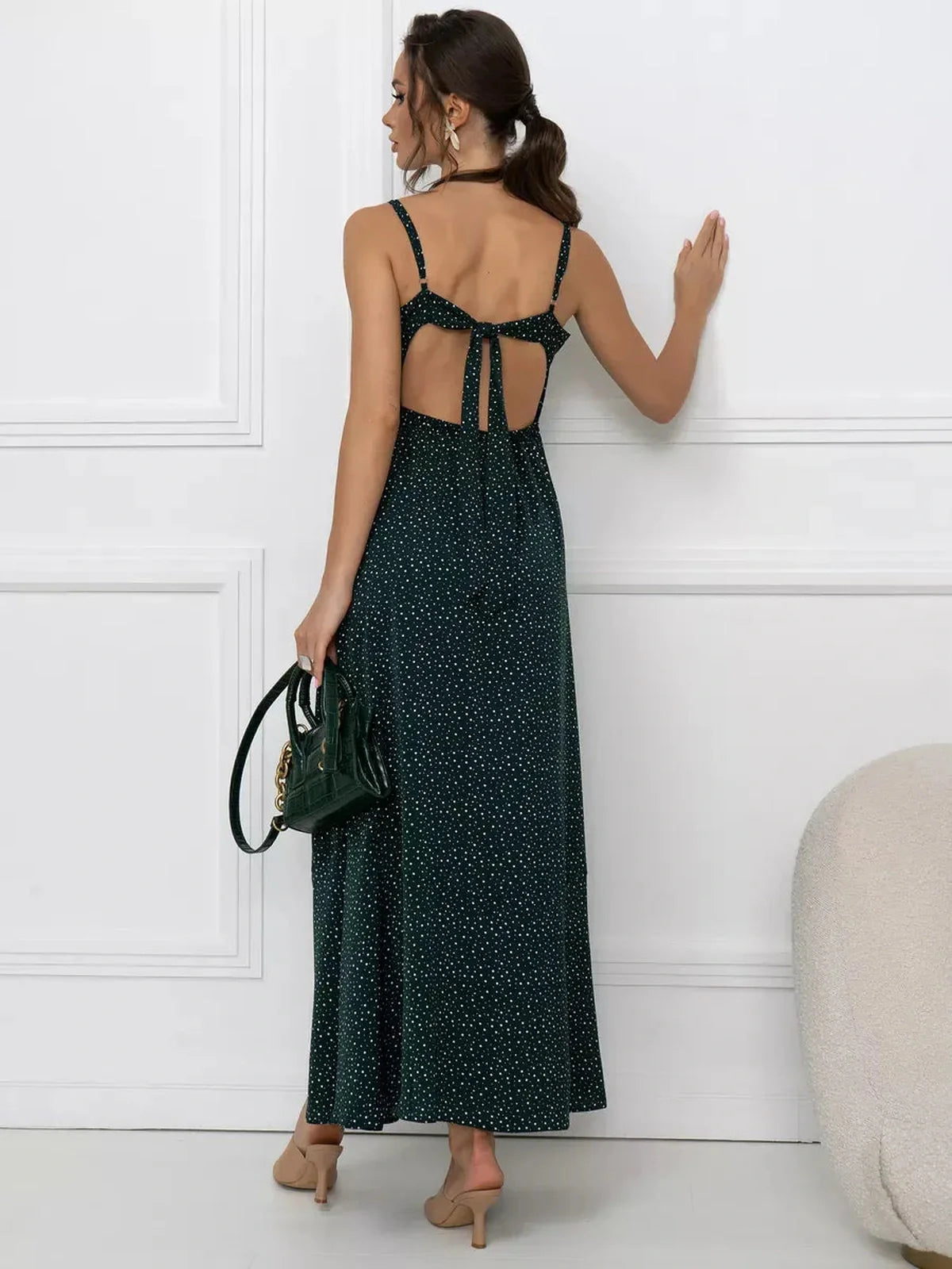 Emerald Whisper Maxi Dress showcasing a back tie detail, dotted print, and A-line silhouette for effortless elegance.