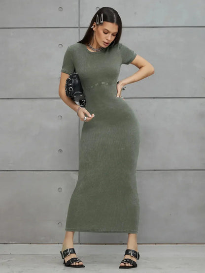 Olive Line Maxi Dress in khaki green ribbed cotton, featuring a fitted ankle-length silhouette and stylish accessories.