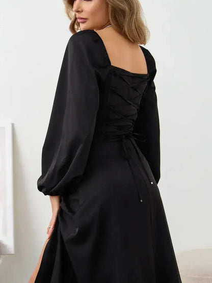 Elegant Velvet Aura black corset dress showcasing structured neckline and voluminous sleeves in a stylish back view.