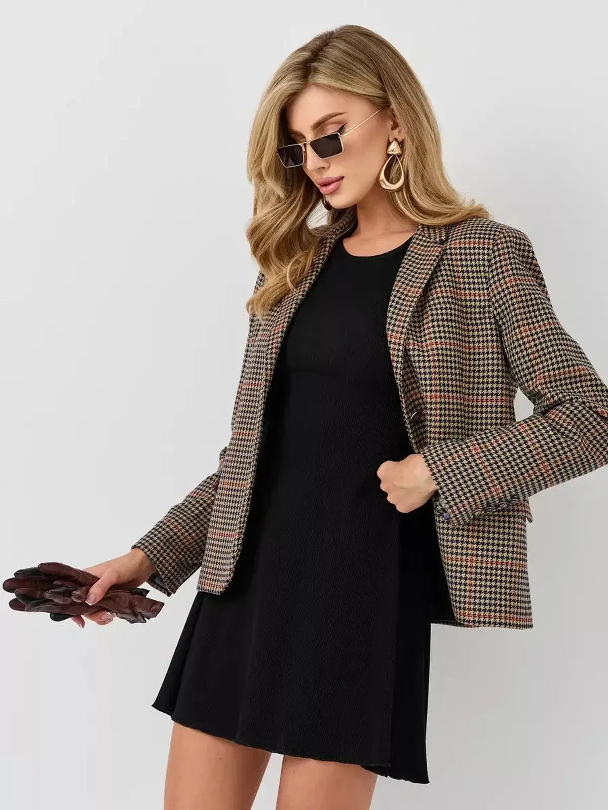 Model showcasing a stylish black dress paired with a plaid blazer and accessories, perfect for business casual or formal occasions.