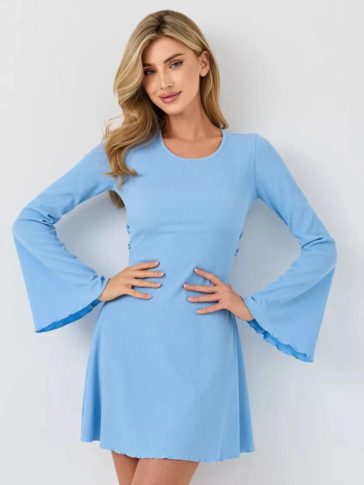 Model showcases a pastel blue ribbed knit mini dress with flared sleeves and A-line silhouette, perfect for summer occasions.