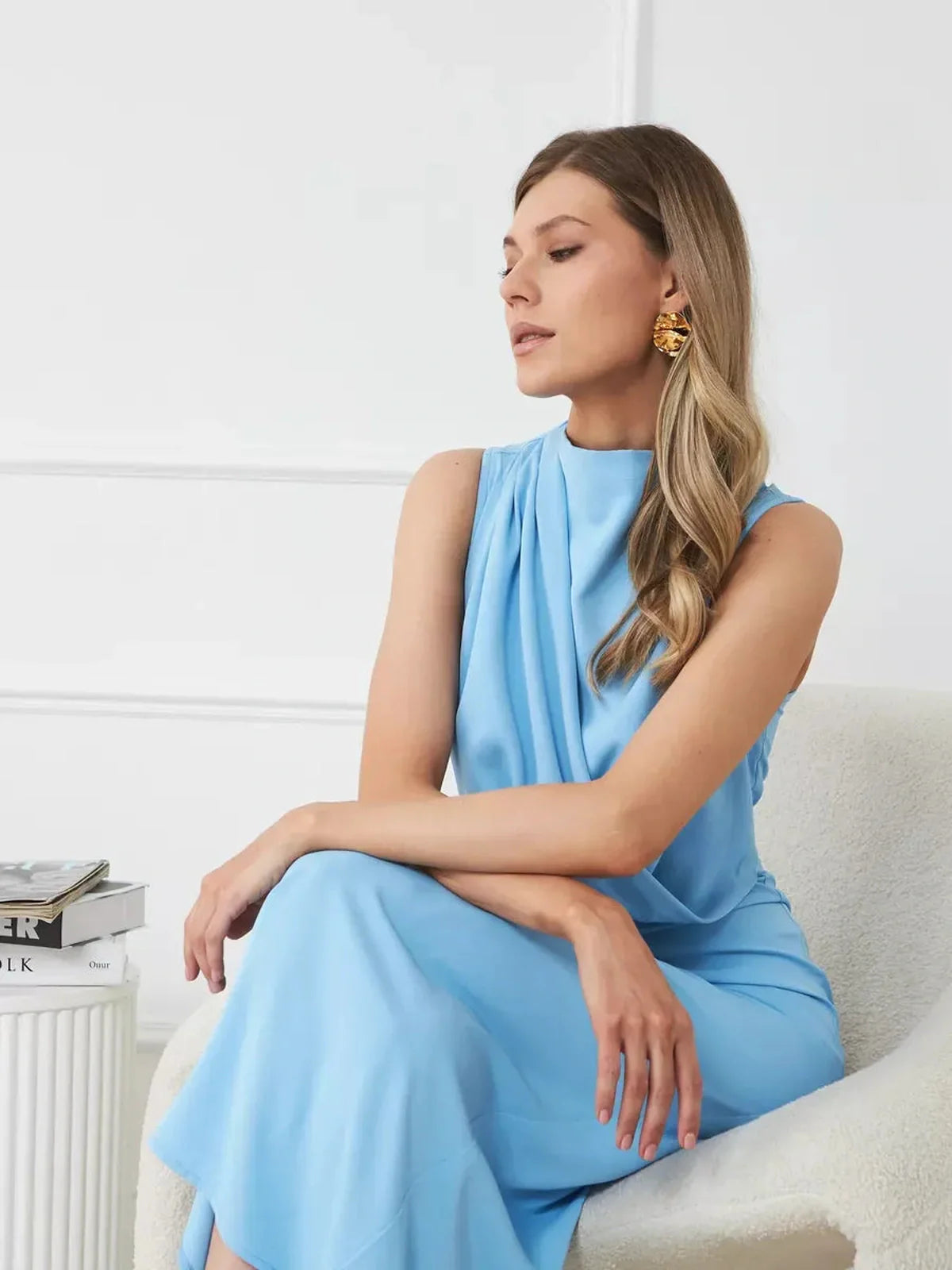 Model wearing the Sculpted Grace Maxi Dress in blue, showcasing its draped silhouette and elegant style.