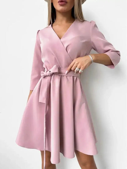 Elegant pink mini dress with V-neckline, long sleeves, and fitted waist featuring a removable belt, perfect for any occasion.