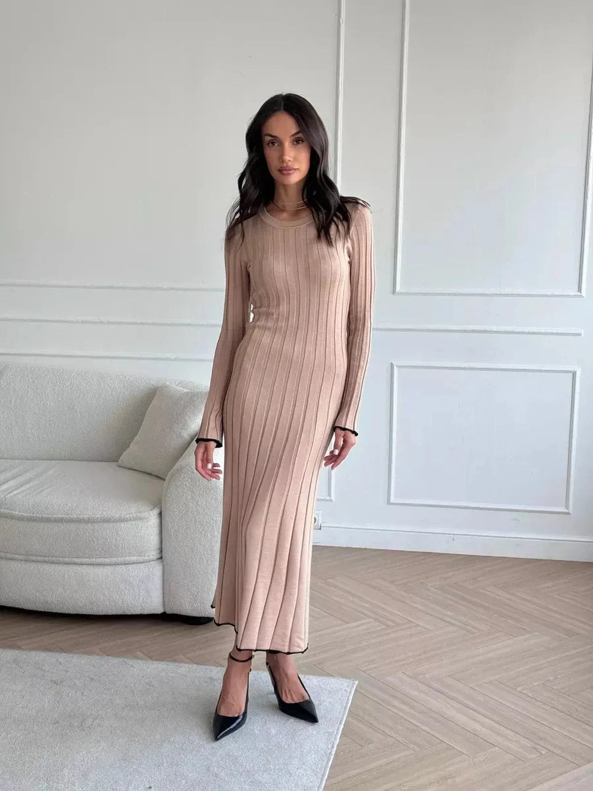 Model wearing the Sahara Curve Maxi Dress in sandstone beige, showcasing a soft ribbed texture and elegant full-length design.