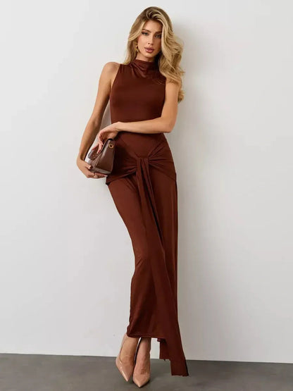 Model wearing the Mocha Muse Maxi Dress, featuring a draped front knot and elegant high neckline in a chic earthy tone.