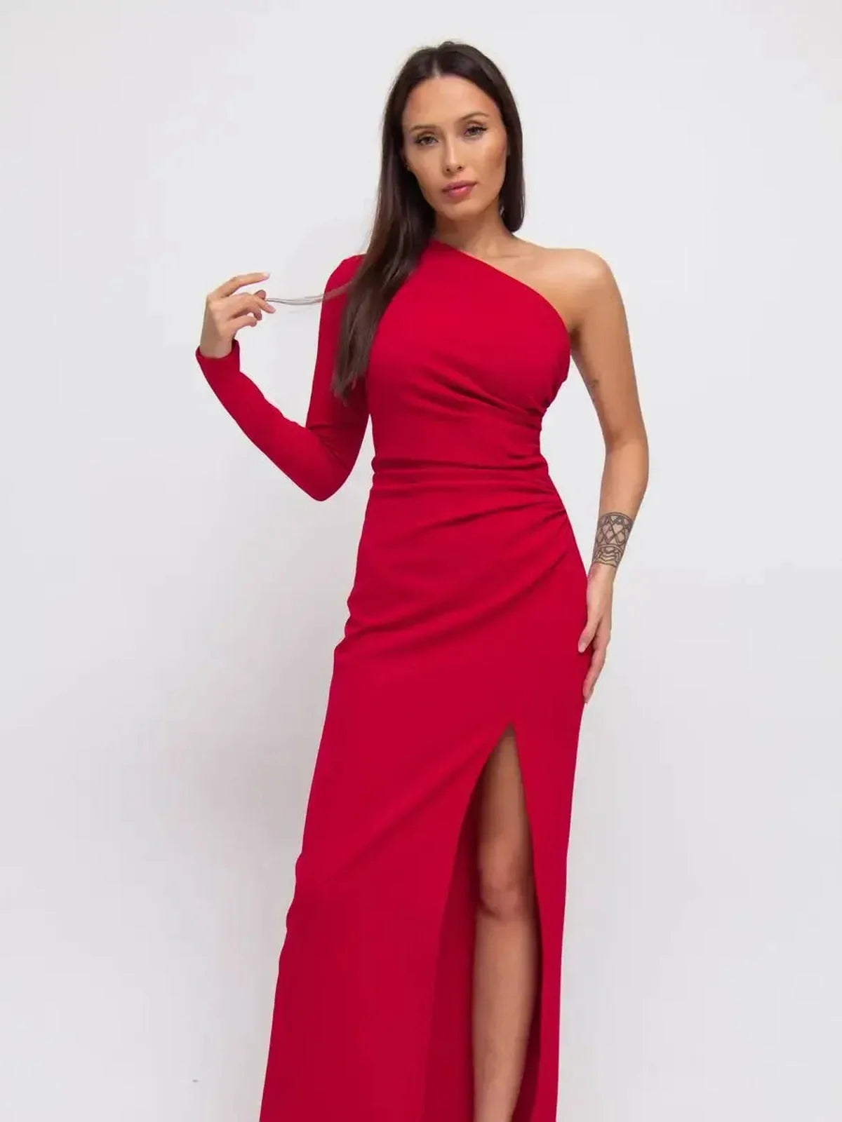 Model showcasing the striking Maxi Dress Radiance in deep red, featuring a one-shoulder design and thigh-high slit.