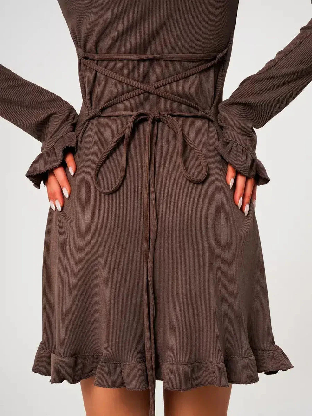 Back view of Mocha Flare ribbed knit mini dress featuring flared sleeves and ruffled hem detail, showcasing the soft fabric.
