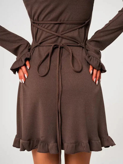 Back view of Mocha Flare ribbed knit mini dress featuring flared sleeves and ruffled hem detail, showcasing the soft fabric.