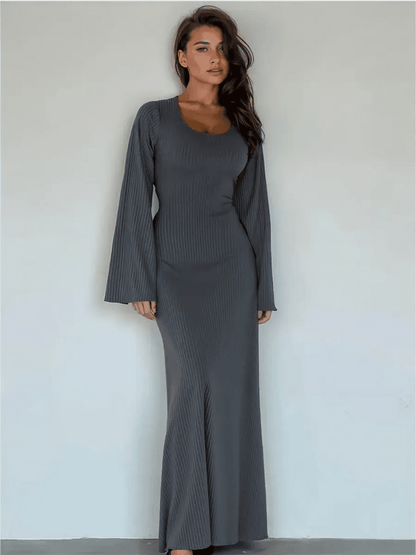 Stunning model wearing the Granite Luxe Maxi Dress with flared sleeves and ribbed texture in elegant gray.
