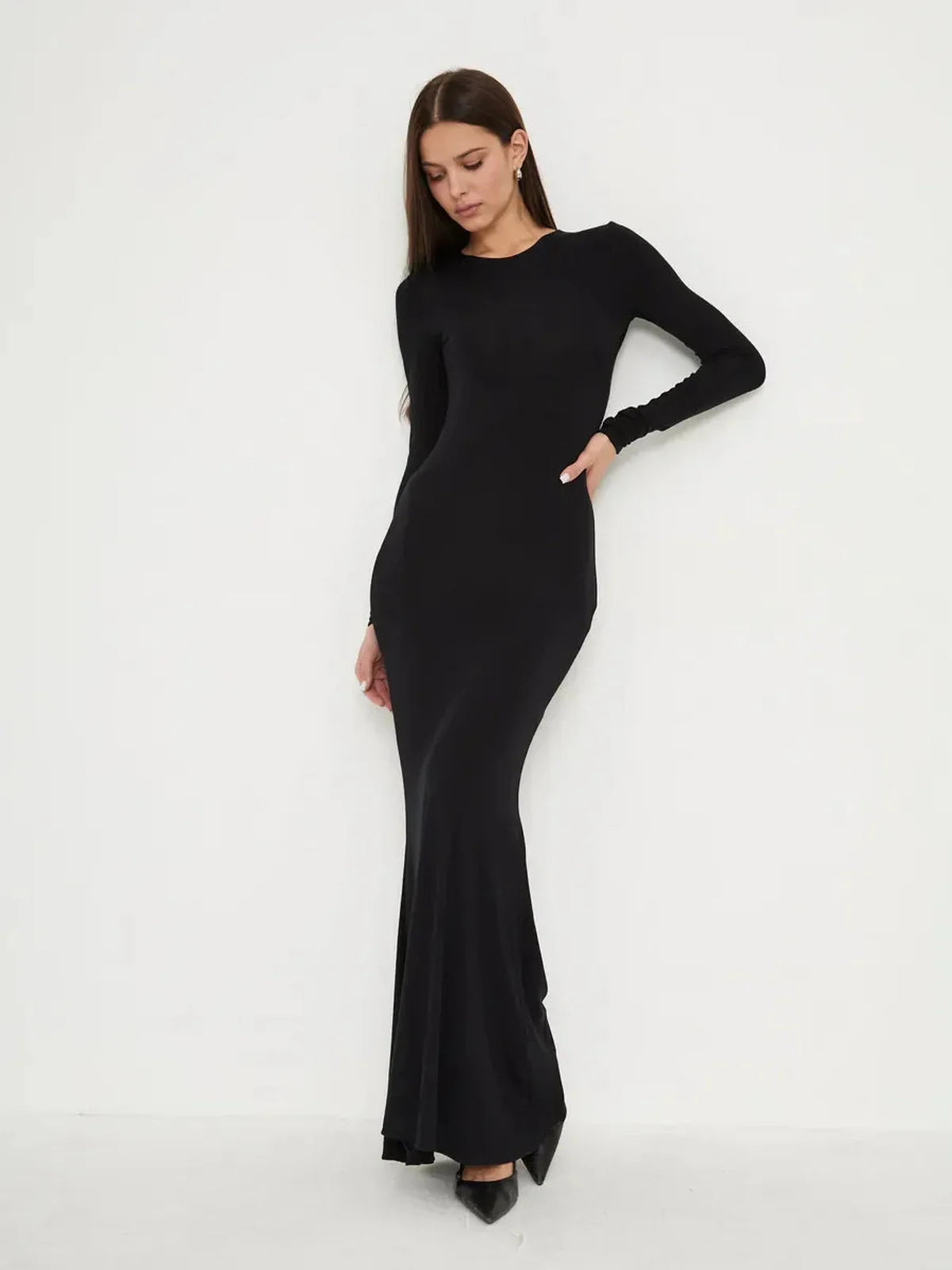 Elegant full-length black dress, Sculpted Noir, featuring a second-skin fit and mermaid hem for a sleek silhouette.