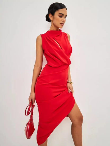Stylish woman wearing a red drape maxi dress with an elegant neckline and draped silhouette, holding a matching handbag.