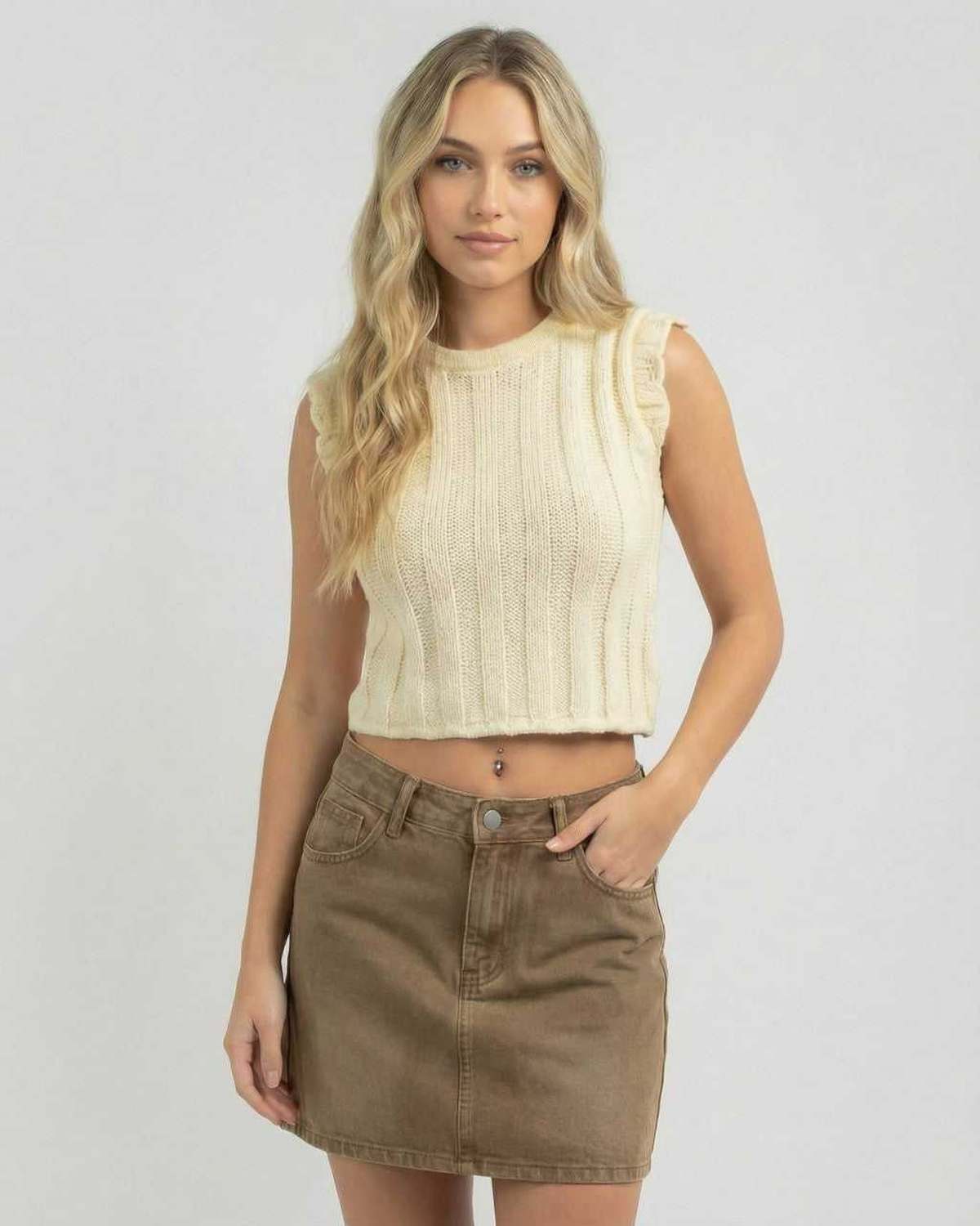 Woman wearing Lauven Monaco Top, a sleeveless knit top, with a casual summer skirt.