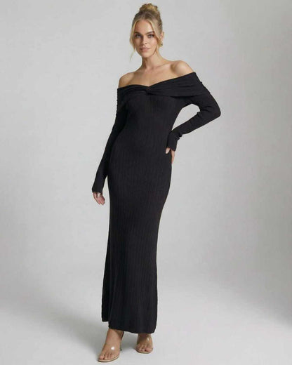 Off-the-shoulder model wearing Noir Maxi Dress by Lauven, showcasing a sleek ribbed black bodycon design.