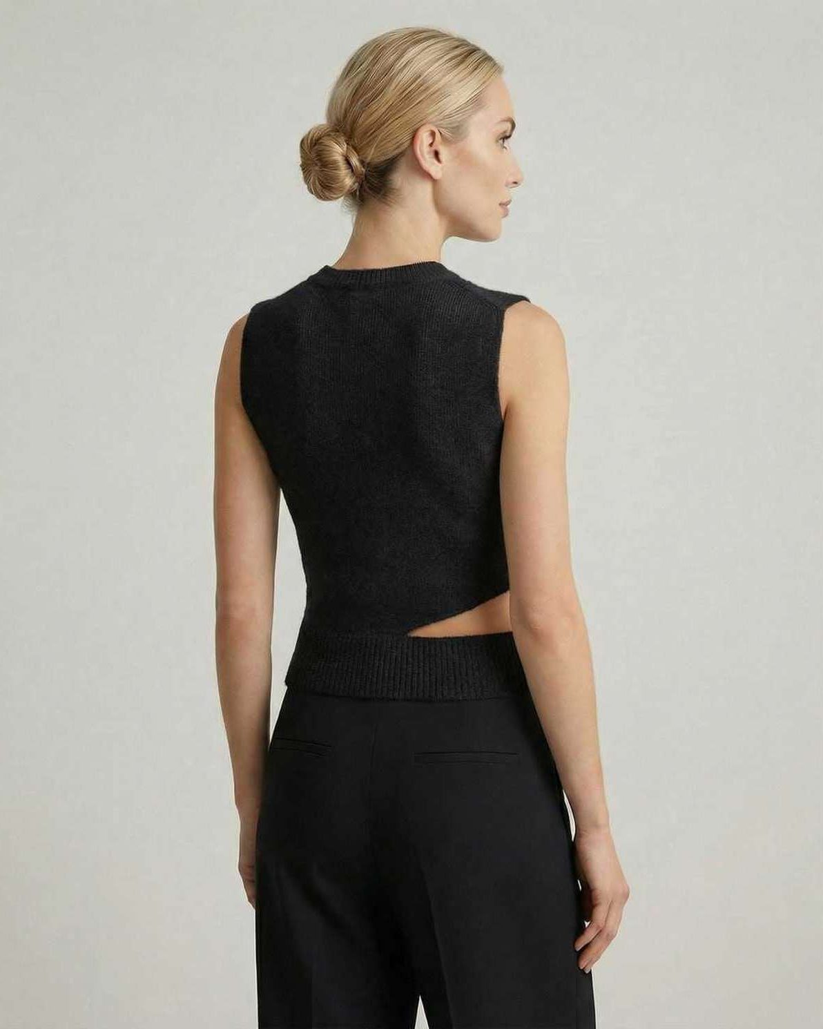 Noiré Top by Lauven – Women’s black sleeveless knit top with elegant cutout design, showcasing a modern silhouette.