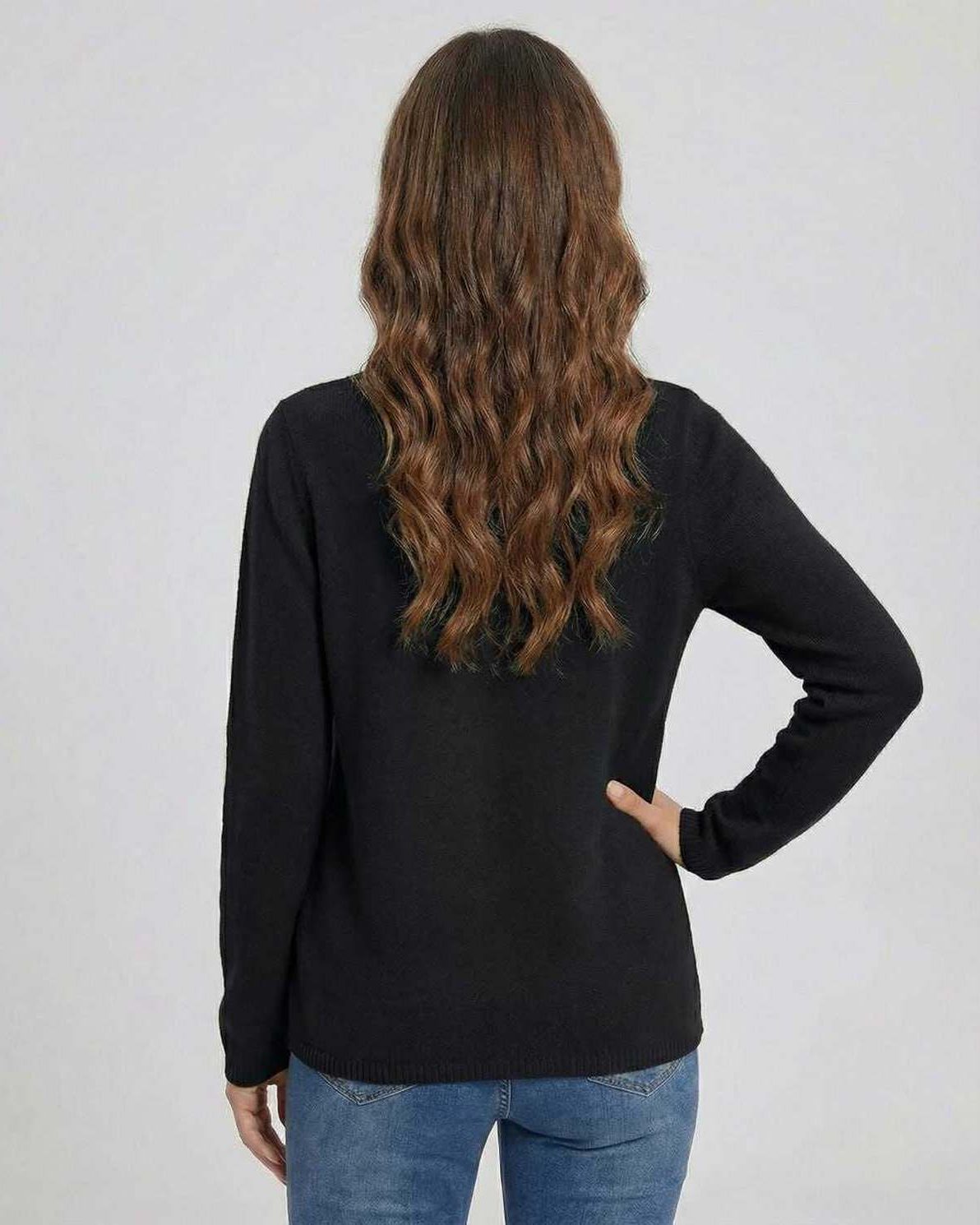 Back view of a woman wearing the Noiré Sweater by Lauven, a stylish black V neck sweater with button detail.
