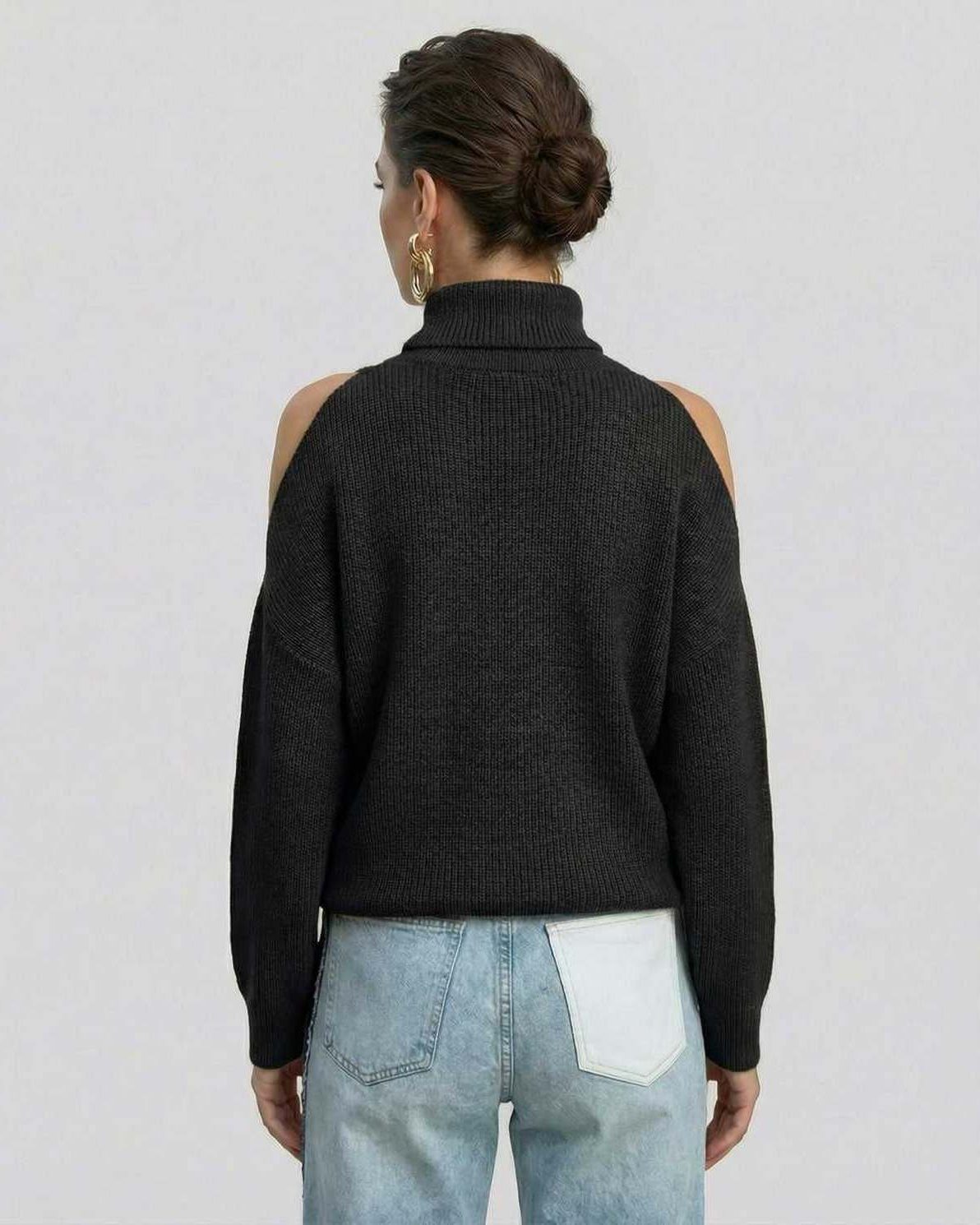 Back view of a woman wearing a Lauven Monaco Sweater, a black turtleneck with cutout shoulders.