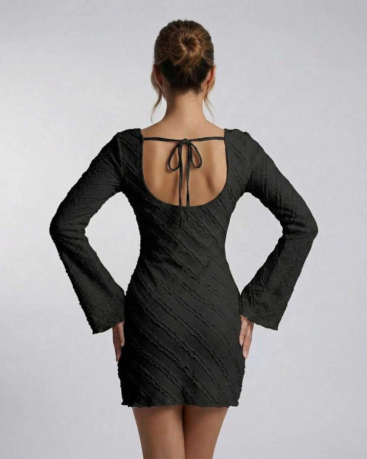 Back view of the Lauven Monaco Mini Dress showing long sleeves and textured finish.