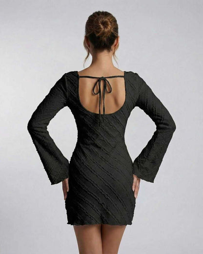 Back view of the Lauven Monaco Mini Dress showing long sleeves and textured finish.