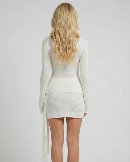 Back view of the Sienna Mini Dress by Lauven, showcasing its fitted waist and long sleeves.