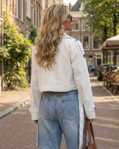 Milano Jacket by Lauven worn by a model outdoors, showcasing a chic white cropped trench design.