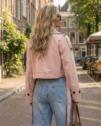 Blush Jacket by Lauven – Women’s pink cropped trench jacket on model in urban setting.