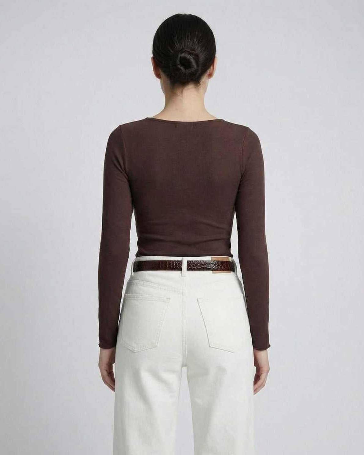 Back view of model wearing Sienna Long Sleeve brown top paired with white jeans.