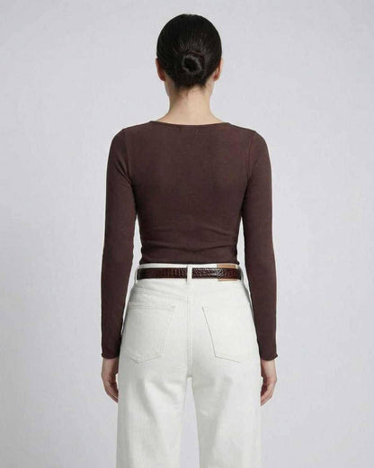 Back view of model wearing Sienna Long Sleeve brown top paired with white jeans.