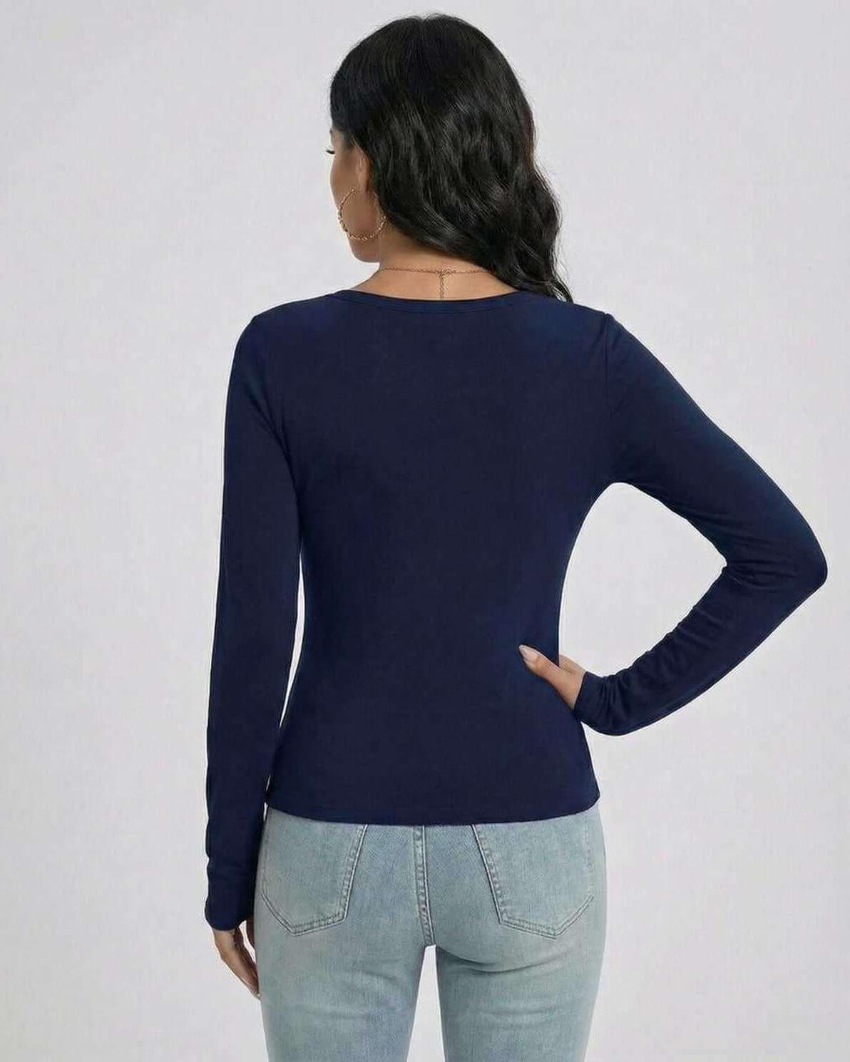 Back view of a woman wearing a navy Monaco Pullover by Lauven, showcasing its sleek slim fit and long sleeves.