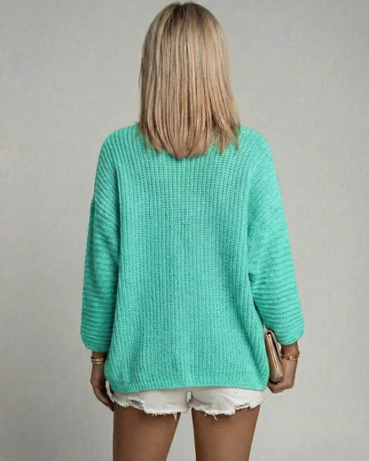 Women wearing the Mint Aura Cardigan by Lauven, showcasing the back view in mint green knit.