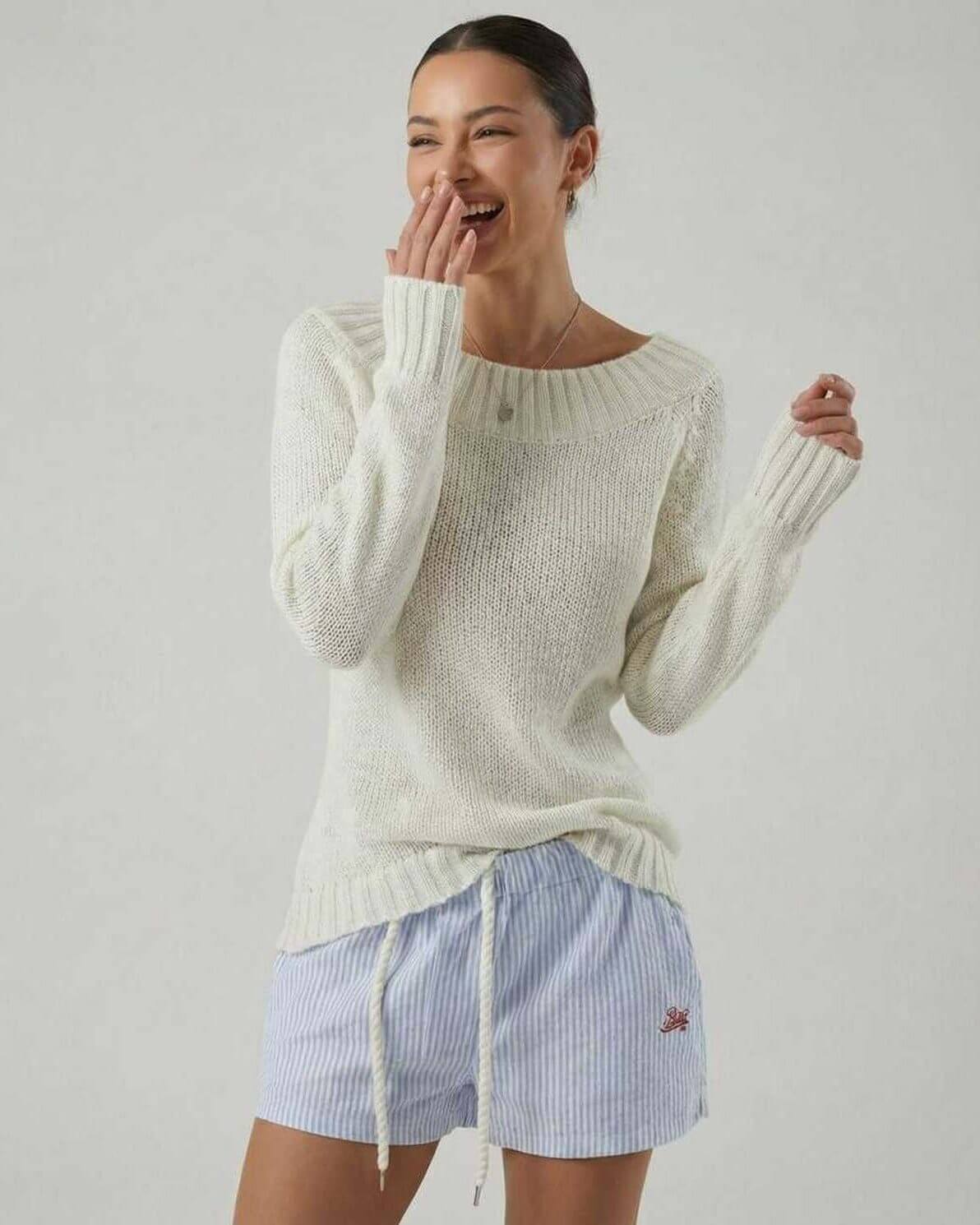 Smiling woman wearing the Sienna Sweater by Lauven, showcasing a boat neck style and relaxed fit.