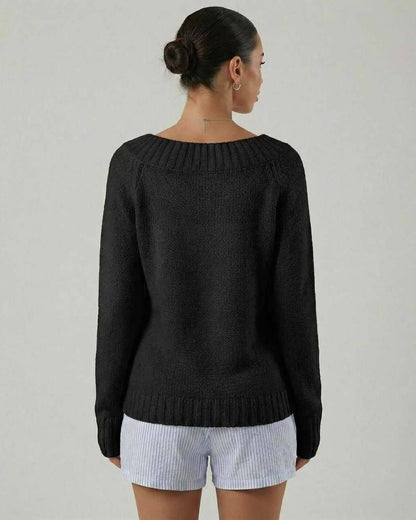 Back view of a woman wearing the Lauven Monaco Sweater, a sleek black boat neck sweater with rib knit detail.